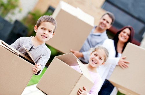 Local movers handling a sofa in a North London flat